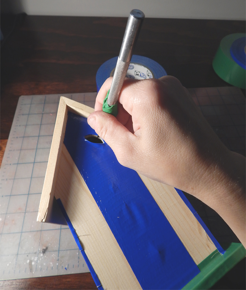 Using an x-acto knife blade to cut out holes and edges in the Pro Duct 120 in Blue