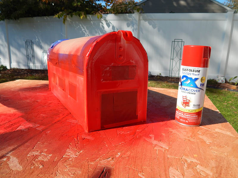 Spray painting the mailbox after masking with tape