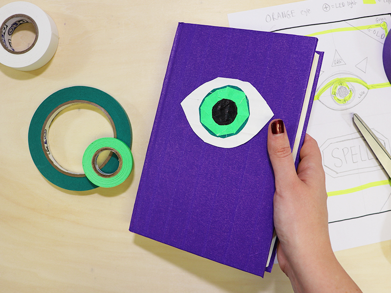 the tape artwork eye on the spellbook cover